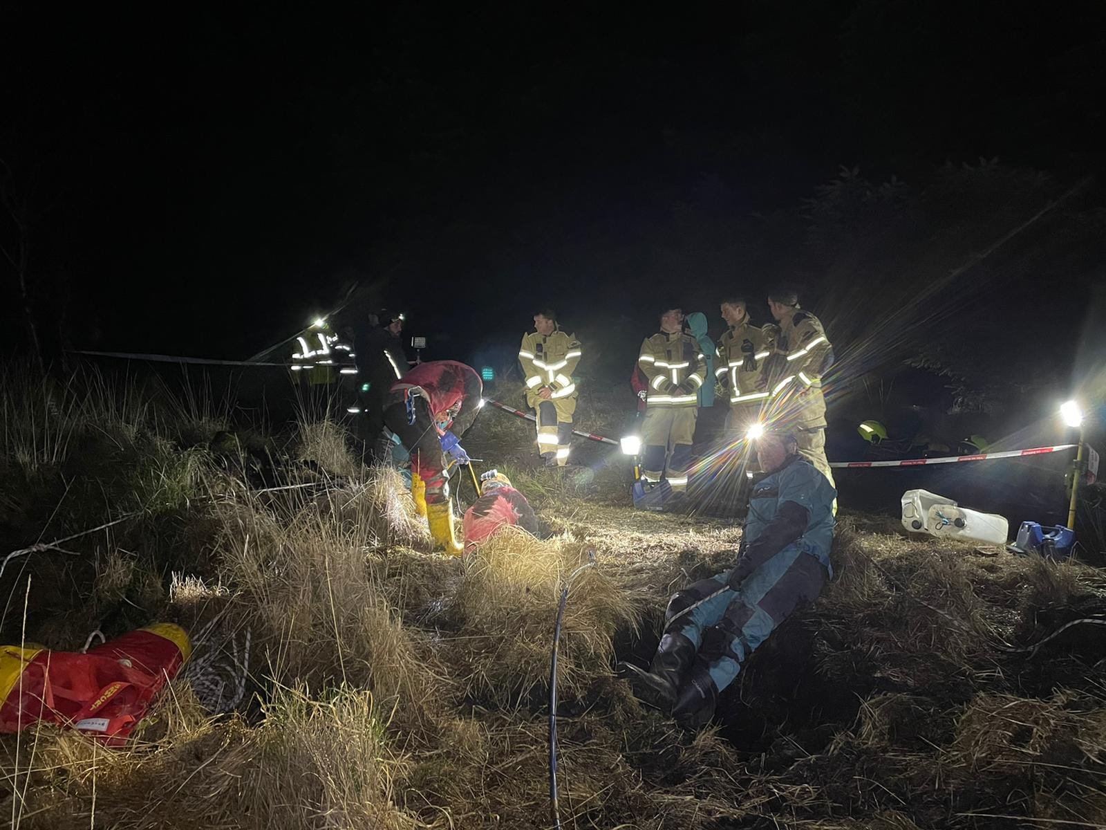 A pet dog is lucky to be alive after being pulled to safety from a 22ft deep cave - in a massive overnight rescue operation. Spaniel Reggie was stuck in the deep crevice on a mountainside in the 34-hour rescue. He had been out for a walk with his owner Leah Davies when he disappeared out of sight and sparked a search. Firefighters and cave rescuers rushed to Llwynypia Mountain near Tonypandy, South Wales, to help find Reggie. Pictured here is the rescue WALES NEWS SERVICE